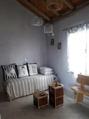 a room with a bed with pillows and a table at Complejo Yarken in Potrero de Garay