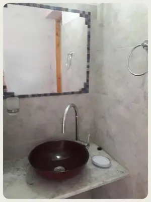 a bathroom with a brown sink and a mirror at Complejo Yarken in Potrero de Garay