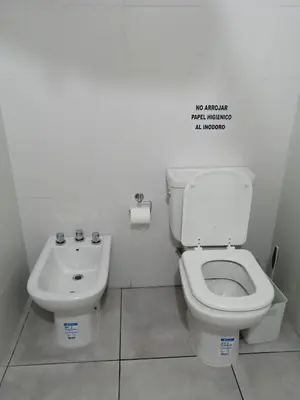 a bathroom with a toilet and a sink at Casa hasta 10 personas. in Villa Rumipal