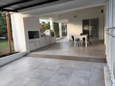 a patio with a table and a kitchen and a dining room at Casa hasta 10 personas. in Villa Rumipal
