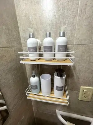 a group of bottles and cups on a shelf in a bathroom at Depto La Leda in Almafuerte
