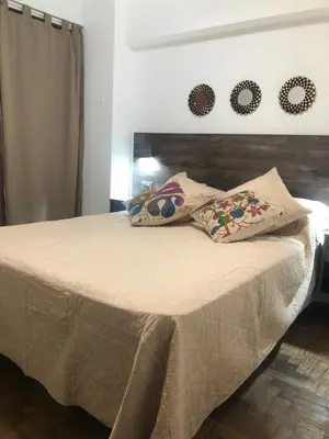 a bed with two pillows on it in a bedroom at Departamento HMP en la mejor zona Cordoba in Cordoba