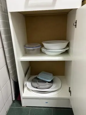 a white cabinet with plates and bowls in it at Departamento HMP en la mejor zona Cordoba in Cordoba