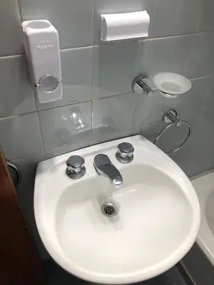 a bathroom with a white sink and a mirror at Departamento HMP en la mejor zona Cordoba in Cordoba