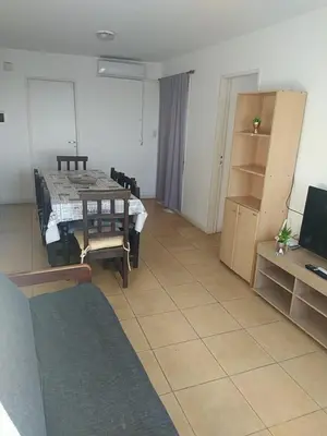 a living room with a table and a room with a room at Costanera 3 dormitorios 2 cocheras estamos a 800 metros del centro in Cordoba