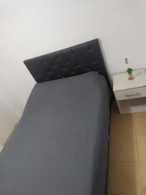 a black bed in a room with a desk at Costanera 3 dormitorios 2 cocheras estamos a 800 metros del centro in Cordoba