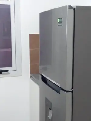 a refrigerator in a kitchen with a window at Costanera 3 dormitorios 2 cocheras estamos a 800 metros del centro in Cordoba