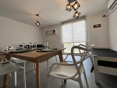 a dining room with a wooden table and chairs at “Tu lugar en Cordoba 02” Depto SADIMA Guemes in Cordoba