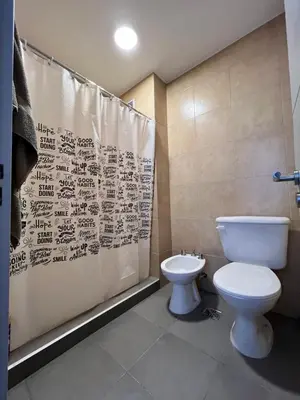 a bathroom with a toilet and a shower curtain at “Tu lugar en Cordoba 02” Depto SADIMA Guemes in Cordoba