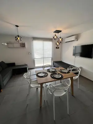 a living room with a table and chairs and a couch at “Tu lugar en Cordoba 02” Depto SADIMA Guemes in Cordoba