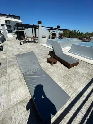 a shadow of a person taking a picture on a patio at “Tu lugar en Cordoba 02” Depto SADIMA Guemes in Cordoba