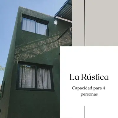 a green building with a window and the words la rica repeated part p p at La Rústica in La Bolsa