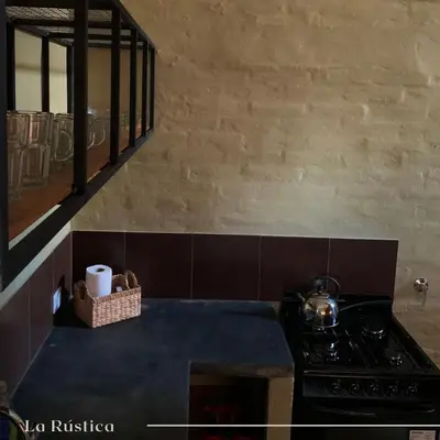a kitchen with a stove and a counter top at La Rústica in La Bolsa