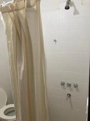 a shower curtain in a bathroom with a toilet at Pacífico Il in Cordoba