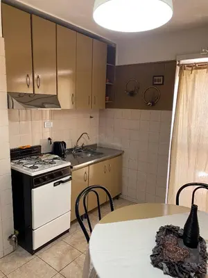 a small kitchen with a stove and a table at Pacífico Il in Cordoba