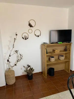 a living room with a television and a tiled floor at Pacífico Il in Cordoba