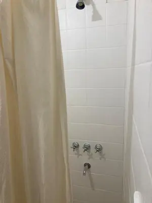 a shower with a shower curtain in a bathroom at Pacífico Il in Cordoba