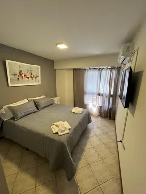 a bedroom with a bed with two towels on it at SUPER UBICACIÓN NUEVA CÓRDOBA in Cordoba