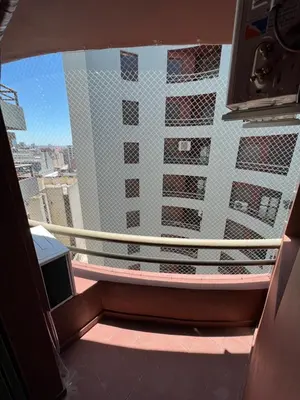 a balcony with a view of a tall building at SUPER UBICACIÓN NUEVA CÓRDOBA in Cordoba