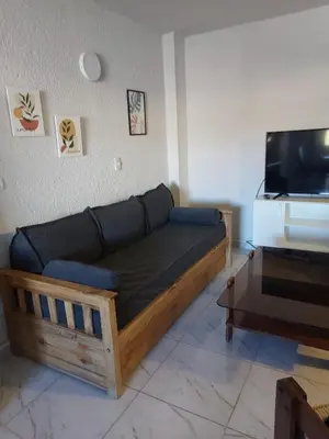 a living room with a couch and a flat screen tv at Departamento 2 dormitorios Villa Carlos Paz in Villa Carlos Paz