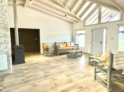 a living room with a couch and a table at Cabaña con spa Vida Abundante in Villa Yacanto