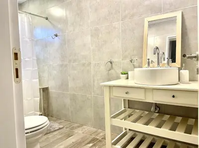 a bathroom with a sink and a toilet at Cabaña con spa Vida Abundante in Villa Yacanto