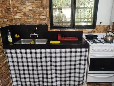 a kitchen with a sink and a stove at Depto Cura Gaucho in Mina Clavero