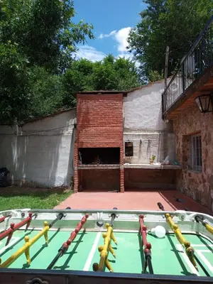 a pool table in front of a building at Depto Cura Gaucho in Mina Clavero