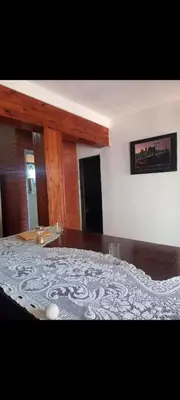 a bedroom with a bed with a white blanket on it at Depto Cura Gaucho in Mina Clavero