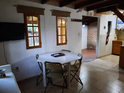 a dining room with a white table and chairs at La Cabañita in Villa General Belgrano