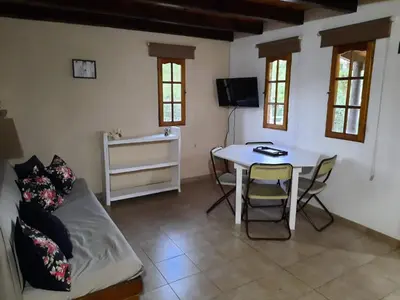 a living room with a couch and a table at La Cabañita in Villa General Belgrano