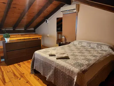 a bedroom with a bed and a dresser at La Cabañita in Villa General Belgrano
