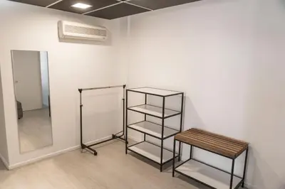 a room with a shelf and a stool next to a wall at Babel Nueva Córdoba in Cordoba