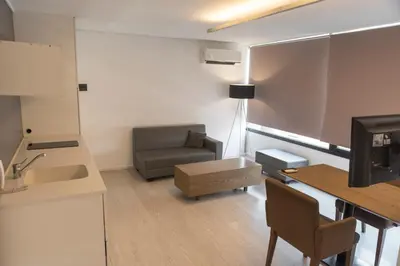a small living room with a couch and a table at Babel Nueva Córdoba in Cordoba