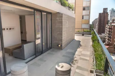 an apartment balcony with a view of the city at Babel Nueva Córdoba in Cordoba