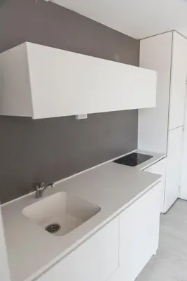 a white kitchen with a sink in a room at Babel Nueva Córdoba in Cordoba