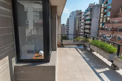 a view from the balcony of a building with a ball in the window at Babel Nueva Córdoba in Cordoba