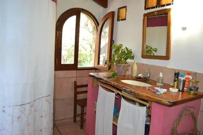a bathroom with a sink and a mirror at Atardecida in Villa de Las Rosas