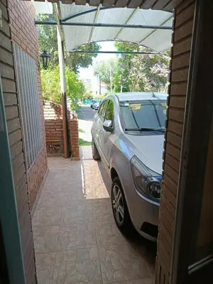 a car parked in a garage next to a building at Casa en Carlos Paz in Villa Carlos Paz