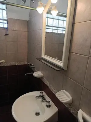 a bathroom with a white sink and a mirror at Casa en Carlos Paz in Villa Carlos Paz