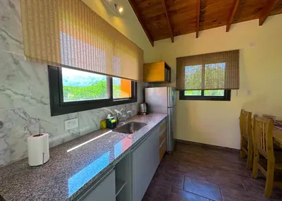 a kitchen with a sink and a refrigerator at Complejo La Dorada in Merlo