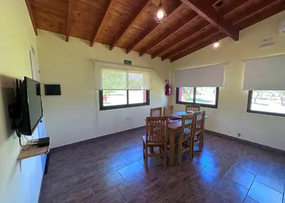 a living room with a dining room table and chairs at Complejo La Dorada in Merlo