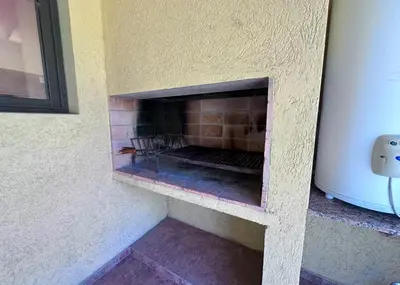 a brick fireplace in the corner of a room at Complejo La Dorada in Merlo