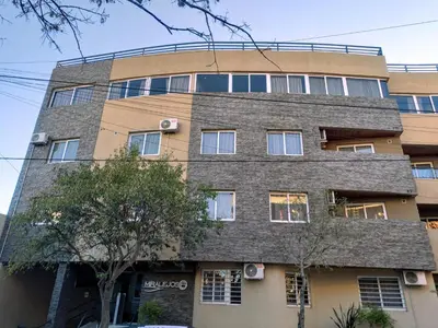 an apartment building with a stone facade at MIRALEJOS 6 CENTRO in Villa Carlos Paz