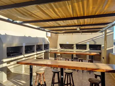 a row of tables and stools in a kitchen at MIRALEJOS 6 CENTRO in Villa Carlos Paz