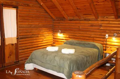 a bedroom with a bed in a log cabin at La Soñada Cabañas & Spa in Merlo