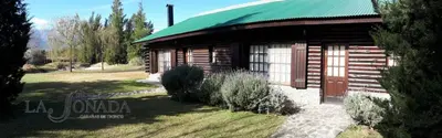 a small wooden building with a green roof at La Soñada Cabañas & Spa in Merlo