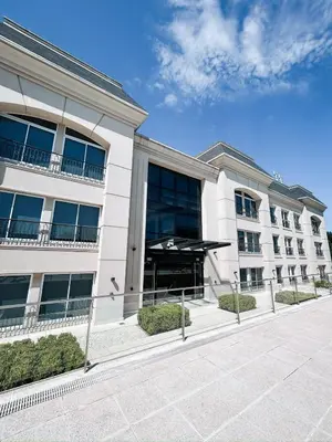 a large white building with a lot of windows at Apart France - Un dormitorio con gim, piscina y estacionamiento in Río Cuarto