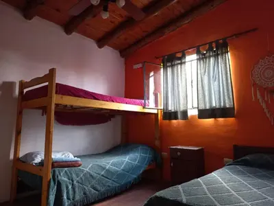 a bedroom with two bunk beds and a window at cabañas fátima in Villa de Las Rosas