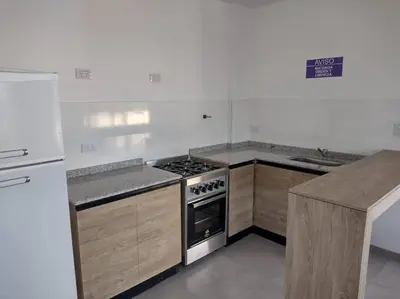 a kitchen with a stove and a refrigerator at Dto a estrenar Ctro V Carlos Paz in Villa Carlos Paz